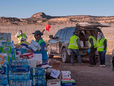 Native Americans of the Navajo Nation pick up supplies from a food bank set up at the Navajo Nation town of Casamero Lake in New Mexico on May 20, 2020.