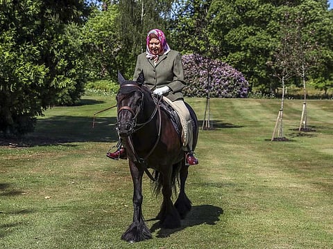 Britain's Queen Elizabeth II rides Balmoral Fern, a 14-year-old Fell pony, in Windsor Home Park, in Windsor, Britain, in this undated pool picture released on May 31, 2020. 
