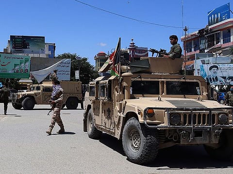 Afghan security forces sit in a Humvee vehicle amid ongoing fighting between Taliban militants and Afghan security forces in Kunduz. 