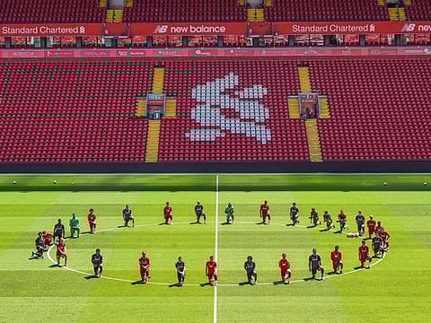 Liverpool players, poised to take the title, players take a knee for George Floyd during training at Anfield.