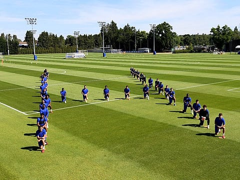 Chelsea FC players pay their tributes to George Floyd before their training session in Cobham, England on Tuesday.