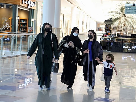 Women wear face masks as they walk at the Hayat mall after restaurants and malls reopened as the government eases the coronavirus lockdown restrictions, in Riyadh,