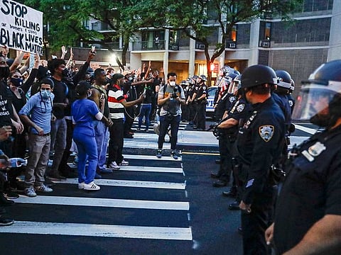 Protesters confront New York Police officers as part of a solidarity rally calling for justice over the death of George Floyd, Wednesday, June 3, 2020, in the Brooklyn borough of New York. Floyd died after being restrained by Minneapolis police officers on Memorial Day. 