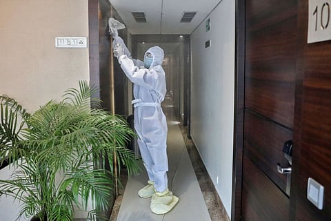 A worker wearing protective gear cleans a hotel corridor before its reopening next week, after some restrictions were lifted during an extended nationwide lockdown to slow the spread of the coronavirus disease (COVID-19), in Kolkata, India, June 5, 2020. 