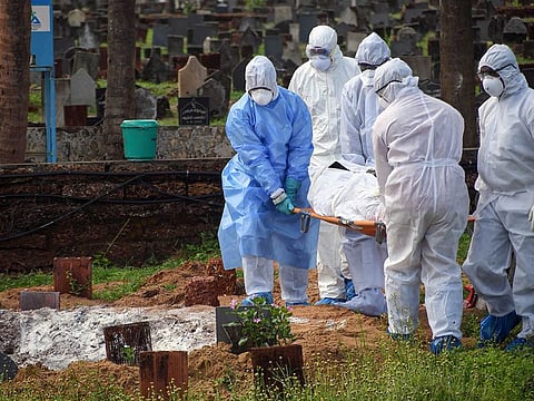 File photo: Health workers and family members perform burial of a person who died of COVID-19, at Kannamparamba in Kozhikode, Kerala, on June 1, 2020. 