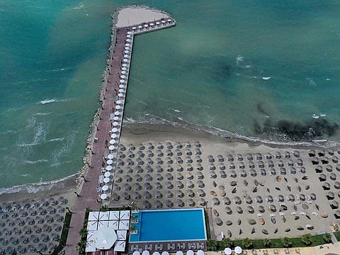 An aerial photograph taken on June 1, 2020, shows straw sun umbrellas at a beach in Qerret near the city of Kavaja. Albania opened its land borders on June 1st and approved further easing measures, allowing most activities bar large public gatherings, public transport and weddings to resume. Hotel beaches also opened on June 1st and on June 6th all public beaches will open. A magnitude-4.2 earthquake hit western Albania.
