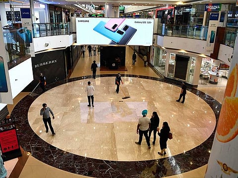 Customers walk inside Select CITYWALK mall after the government eased a lockdown imposed as a preventive measure against the COVID-19 coronavirus in New Delhi, on June 8, 2020. 