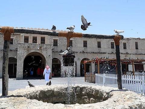 Pigeons linger around a fountain at Qatar's touristic Souq Waqif bazar in the capital Doha, on May 17, 2020. 93 people have died of the coronavirus in Qatar as of Friday, June 19, 2020.