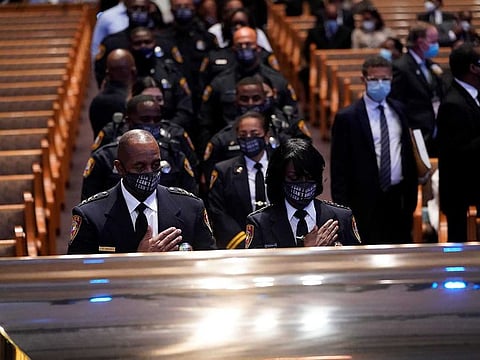 Members of the Texas South University police department pause by the casket of George Floyd during a funeral service at the Fountain of Praise church, in Houston, Texas, U.S., June 9, 2020. 