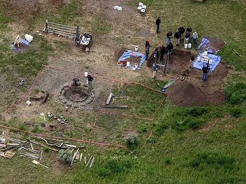 In this aerial photo, investigators search for human remains at Chad Daybell's residence in the 200 block of 1900 east, Tuesday, June 9, 2020, in Salem, Idaho. Authorities say they uncovered human remains at Daybell's home as they investigated the disappearance of his new wife’s two children. Police in the small town of Rexburg say Daybell was taken into custody Tuesday. He had recently married the children’s mother, Lori Vallow Daybell, who has been charged with child abandonment. 
