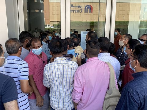 Anxious and impatient visitors crowd around the entrance of the BLS Centre in Deira on 9th June, 2020 