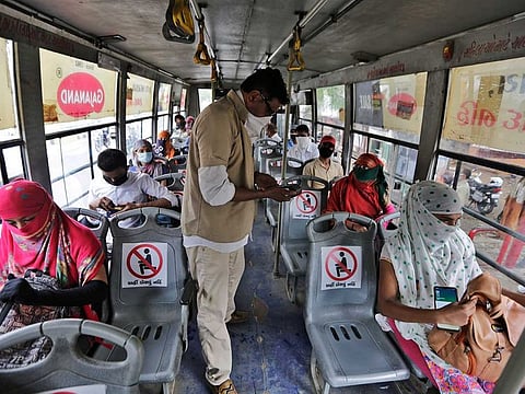 Passengers on a city bus in Ahmedabad, India, Wednesday, June 10, 2020. India's coronavirus cases are spiking amid government reopening restaurants, shopping malls and religious places in most of its states after a more than 2-month-old lockdown. 