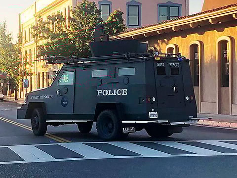 In this image taken from video and provided by KSBY-TV, an armored vehicle patrols the streets of Paso Robles in California's Central Coast region after a sheriff's deputy was wounded after someone opened fire on a police station early Wednesday, June 10, 2020.