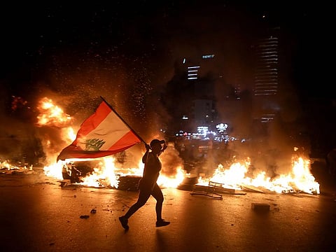 Lebanese protesters block the Jounieh Tripoli highway with flaming tires set aflame during a demonstration against dire economic conditions in Jal el Dib North East of the Lebanese capital Beirut late on June 11, 2020.