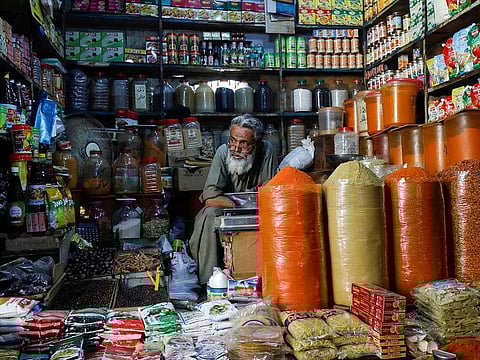 A shopkeeper waits for customers while selling spices and groceries items at the retail market, as the outbreak of the coronavirus disease (COVID-19) continues, in Karachi, Pakistan June 11, 2020. 