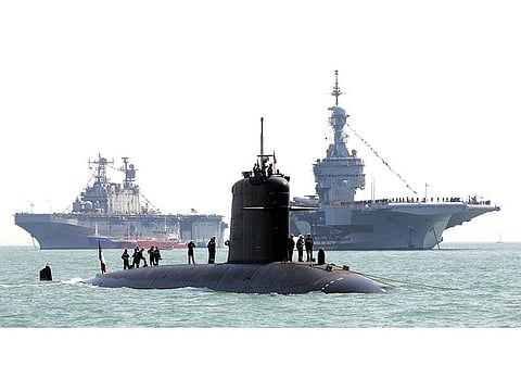 Sailors aboard the French submarine "Perle" (C) inspect the vessel in Portsmouth ahead of celebrations.  A fire broke out on June 12, 2020 on board of the 'Perle', one of the French army's six nuclear-powered attack submarines, but without causing any injuries, while it underwent inspections at Toulon naval base. 