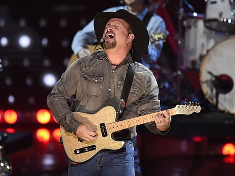 FILE - This March 14, 2019 file photo shows Garth Brooks performing at the iHeartRadio Music Awards in Los Angeles. Brooks is holding a concert in Nashville,Tenn., that will be played at 300 drive-in theaters across the country. Tickets will cost $100 per passenger car or truck. (Photo by Chris Pizzello/Invision/AP, File)