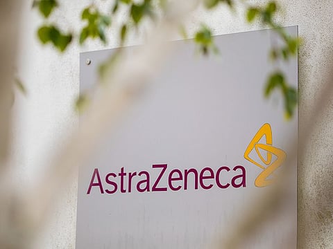 A sign featuring the AstraZeneca Plc logo stands at the company's DaVinci building at the Melbourn Science Park in Cambridge, UK. 
