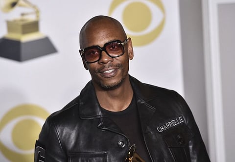 FILE - In this Jan. 28, 2018 file photo, Dave Chappelle poses in the press room with the best comedy album award for "The Age of Spin" and "Deep in the Heart of Texas" at the 60th annual Grammy Awards in New York. Chappelle celebrated George Floyd’s life and ripped the media for the way it handled his death in a surprise Netflix special. The special was released Thursday and is streaming free on Netflix’s comedy YouTube channel.  (Photo by Charles Sykes/Invision/AP, File)