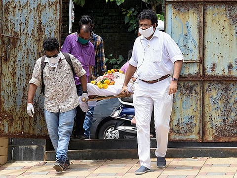 Kins of the oldest living first-class cricketer and historian Vasant Raiji carry his mortal remains as he passes away at his residence, at Malabar Hill in Mumbai, Saturday, June 13, 2020. 