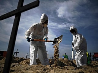 Photos: Brazilian activists dig graves to protest government's handling of COVID-19