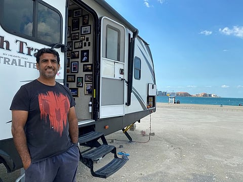 Ali Al Marzouqi in front of his caravan on Al Sufouh Beach in January