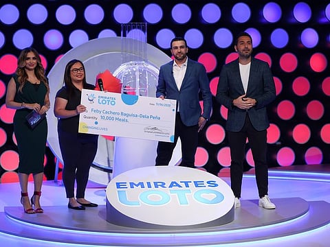 Feby Pena receives an Emirates Loto donation to help her continue to provide free food to residents  