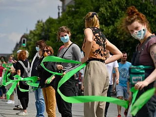Berliners form socially-distanced human chain against racism