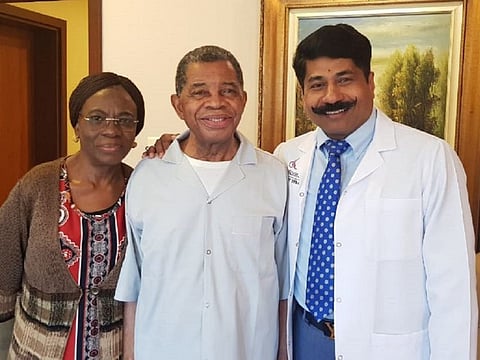 Isaac Ogedengbe with his wife and Dr John Bera