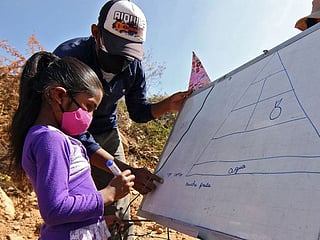 COVID-19: Bolivian teacher on a bike brings school to pupils