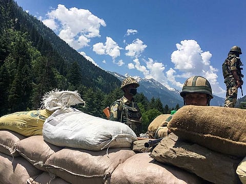 Indian Border Security Force (BSF) soldiers guard a highway leading towards Leh, bordering China, in Gagangir on June 17, 2020. The long-running border dispute between Asian nuclear powers India and China turned deadly for the first time in nearly half a century after at least 20 Indian soldiers were killed in a "violent face-off", the army said on June 16. 