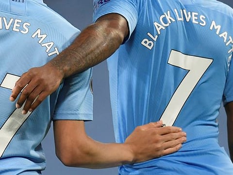 English Premier League players wear 'Black Lives Matter' messages on their shirts.