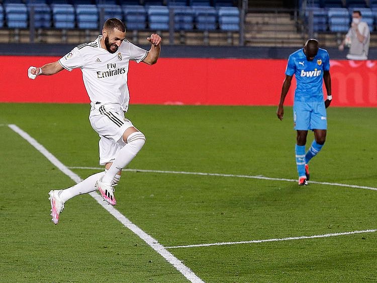 Real Madrid's Karim Benzema celebrates after scoring his side's third goal during the Spanish La Liga soccer match between Real Madrid and Valencia at Alfredo di Stefano stadium in Madrid, Spain, Thursday, June 18, 2020. (AP Photo/Manu Fernandez)