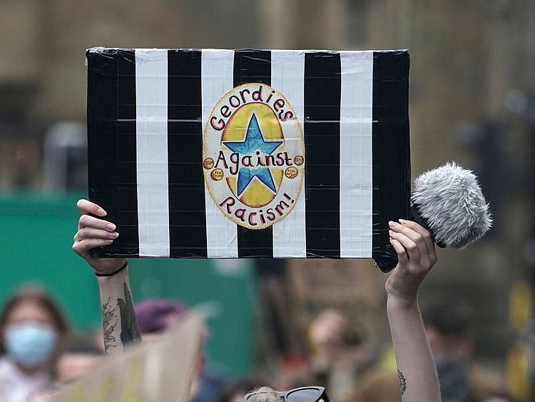 A Newcastle United fan at a Black Lives Matter demonstration