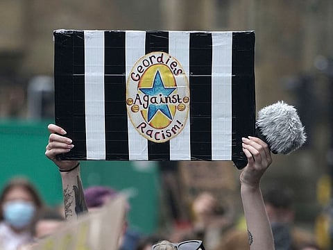 A Newcastle United fan at a Black Lives Matter demonstration.