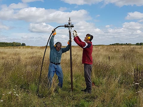 Members of the consortium which made the discovery of a wide circle of deep pits, as part of the Stonehenge Hidden Landscapes Project, conduct fieldwork in Durrington, Wiltshire, Britain August 2019.  