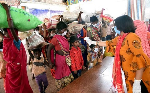 Migrants undergo thermal screening as they arrive at Patna railway station traveling from Rajasthan by special train to reach their destination during the second phase of unlock in Patna.