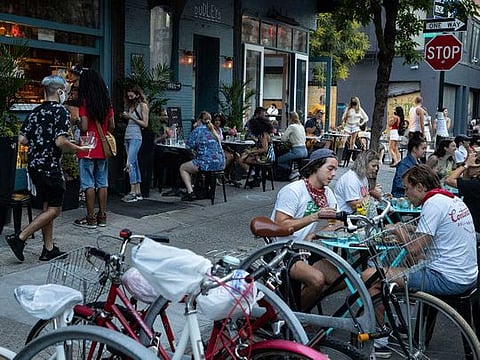 Customers dine outside Dudley's, Monday, June 22, 2020, in New York. New York City ventured into a crucial stage of reopening as stores let people in Monday, offices brought workers back, restaurants seated customers outdoors and residents both welcomed and worried about rebounding from the nation's deadliest coronavirus outbreak.