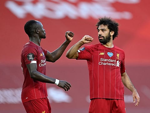 Mohamed Salah celebrates scoring his team’s second goal with Sadio Mane.