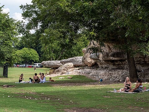 People sit in grous at Zikler Park in Austin, Texas, U.S., on Thursday, June 25, 2020. 