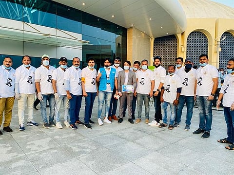 Indian volunteers in T shirts with Nithin Chandran's picture on it