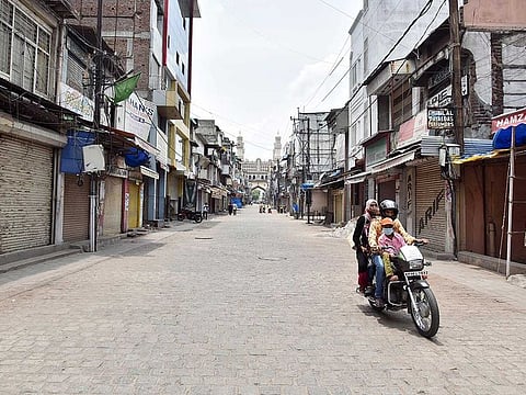 Ghost town... A man rides his bike through a deserted Lad Bazaar Bangle Market in Hyderabad.