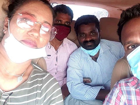 Sheela Thomas with some of the many stranded people she has helped.