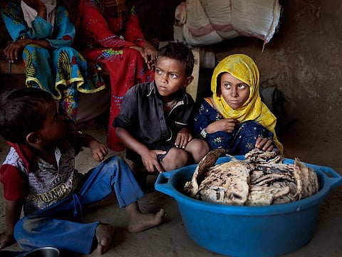File photo: Children sit in front of moldy bread in their shelter, in Aslam, Hajjah, Yemen.