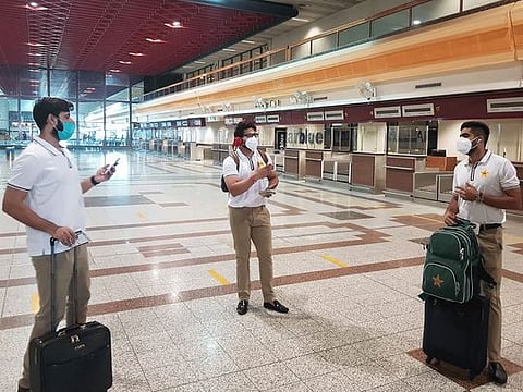 Pakistan cricketers with masks Babar Azam (right), Imad Wasim (left) and Imam-ul-Haq arrive at the Allama Iqbal International airport for their departure to England in Lahore. The squad left for their England tour, but without 10 players who had tested positive for coronavirus. 