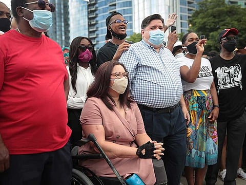 Senator Tammy Duckworth participates with Illinois Governor J.B. Pritzker in a Juneteenth march organised by faith leaders on June 19, 2020 in Chicago, Illinois. 