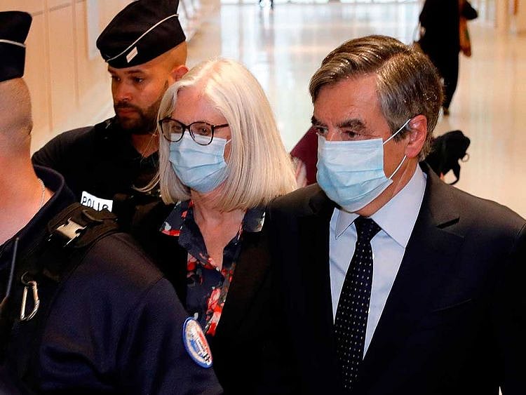 Former French Prime minister Francois Fillon (R) and his wife Penelope Fillon