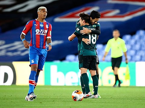 Burnley players embrace after winning their English Premier League match against Crystal Palace.
