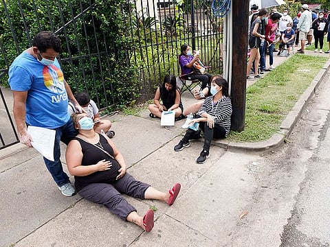 People wait in line at a free COVID-19 testing site provided by United Memorial Medical Center, Sunday, June 28, 2020, at the Mexican Consulate, in Houston. 