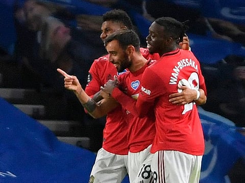 Manchester United’s Bruno Fernandes (C) celebrates scoring their third goal against Brighton.